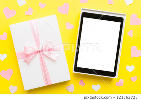 Gift box of open tablet for the holidays with a bow top view Gift box of open tablet for the holidays with a bow top view 121562723