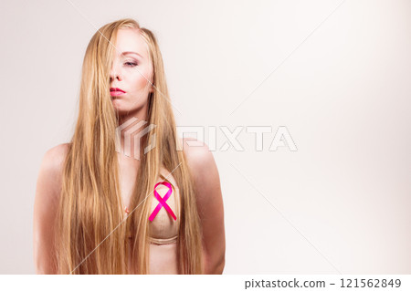 Woman chest in bra, pink cancer ribbon 121562849