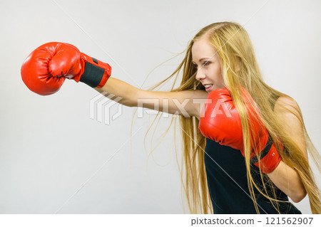 Woman in red gloves boxing 121562907