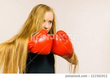Woman in gloves playing sports boxing Woman in gloves playing sports boxing 121562912