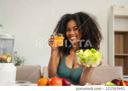 Fit woman enjoys healthy fruit breakfast after yoga training. fitness, nutrition, home lifestyle. 121563441