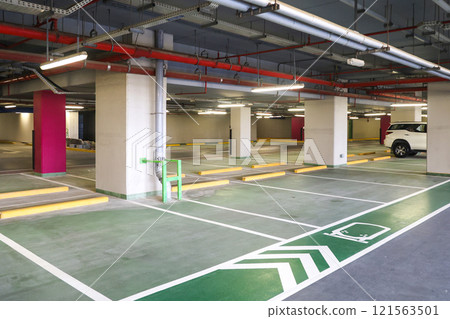 Underground car park in a residential building, a large number of designated spaces for cars Underground car park in a residential building, a large number of designated spaces for cars 121563501