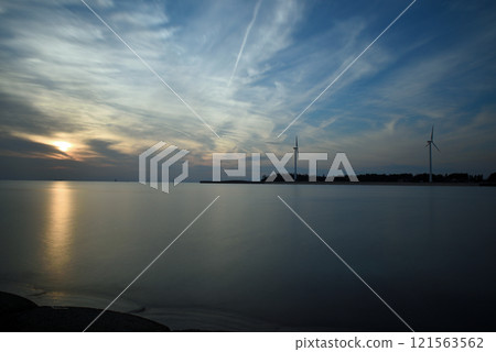 Smooth water surface, sunset at the end of the year 121563562