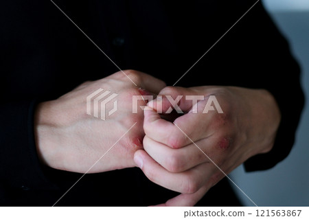 tablet man guy looking at his fingers after boxing holding a tablet in a black shirt standing in the hall tablet man guy looking at his fingers after boxing holding a tablet in a black shirt standing in the hall 121563867