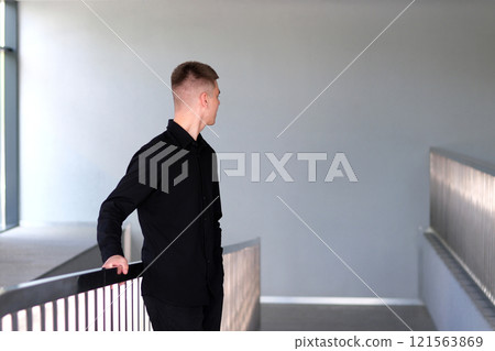 Smiling caucasian businesman in formal outfit looking at camera standing in office. Portrait of happy handsome man wearing suit in open space. Confident corporate worker posing. Smiling caucasian businesman in formal outfit looking at camera standing in office. Portrait of happy handsome man wearing suit in open space. Confident corporate worker posing. 121563869