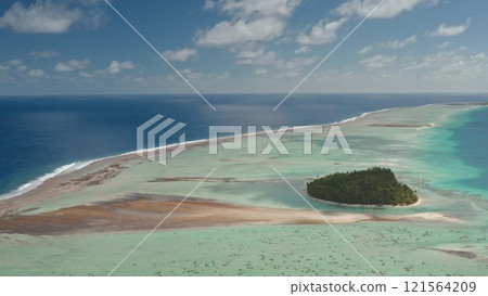 Aerial view of Tikehau island atoll in French Polynesia. Vibrant pink sand and turquoise lagoon, coral reef barrier, and blue ocean under cloudy sky. Remote wild nature paradise, exotic summer travel Aerial view of Tikehau island atoll in French Polynesia. Vibrant pink sand and turquoise lagoon, coral reef barrier, and blue ocean under cloudy sky. Remote wild nature paradise, exotic summer travel 121564209
