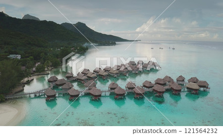 Breathtaking aerial view capturing overwater bungalows in crystal clear turquoise lagoon in Moorea, French Polynesia, offering idyllic luxury escape. Exotic travel vacation getaway, romantic honeymoon 121564232