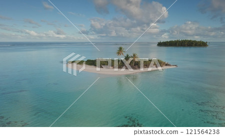 Aerial view panorama of stunning islet in Tikehau, French Polynesia, clear turquoise water, white sand beach, lush palm trees under a cloudy blue sky. Remote wild nature paradise, exotic summer travel Aerial view panorama of stunning islet in Tikehau, French Polynesia, clear turquoise water, white sand beach, lush palm trees under a cloudy blue sky. Remote wild nature paradise, exotic summer travel 121564238