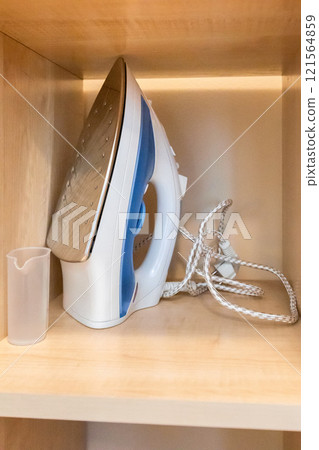 Modern iron on the shelf 121564859