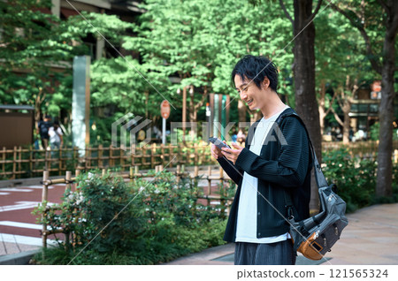 Businessman looking at a smartphone 121565324