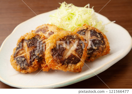 Fried meat stuffed shiitake mushrooms 121566477