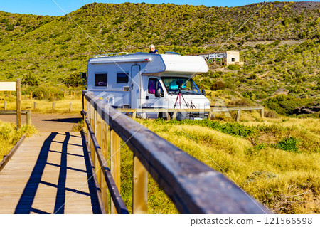 Wooden path on beach with camper camping on coast 121566598