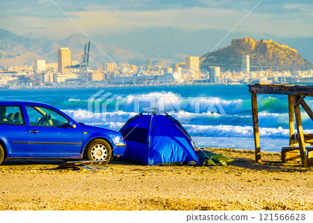 Car and tent on beach. Camping on seashore 121566628