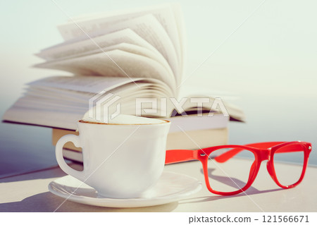 Coffee cup and book outdoor 121566671