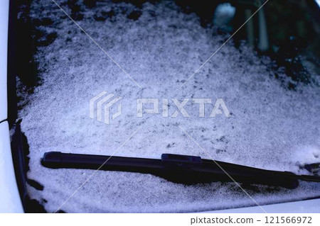 white car is covered with ice and snow 121566972