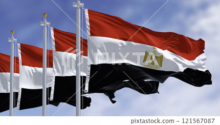 National flags of Egypt waving in the wind on a clear day National flags of Egypt waving in the wind on a clear day 121567087
