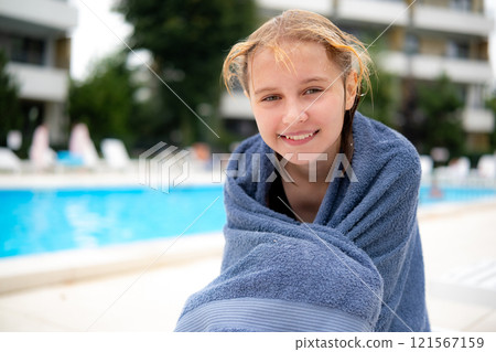 Cute Girl Sitting The Swimming Hotel Pool, Wrapped In A Towel 121567159
