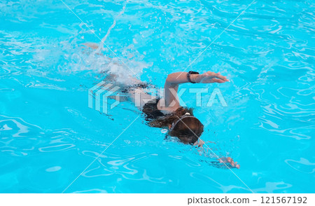 Young Girl Perfecting Front Crawl In Hotel Pool 121567192