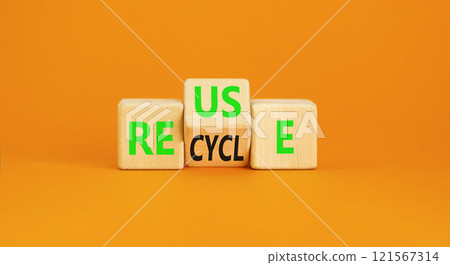 Reuse or recycle symbol. Concept words Reuse Recycle on wooden block. Beautiful orange table orange background. Business reuse or recycle concept. Copy space. 121567314