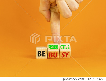 Be productive not busy symbol. Concept words Be productive Be busy on wooden block. Beautiful orange table orange background. Businessman hand. Business be productive not busy concept. Copy space. Be productive not busy symbol. Concept words Be productive Be busy on wooden block. Beautiful orange table orange background. Businessman hand. Business be productive not busy concept. Copy space. 121567322