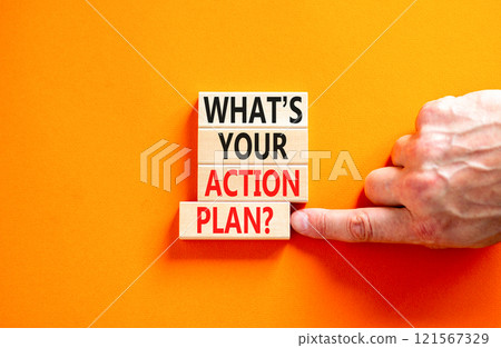 Action plan symbol. Concept words What is your action plan on beautiful wooden blocks. Beautiful orange table orange background. Businessman hand. Business What is your action plan concept. Copy space Action plan symbol. Concept words What is your action plan on beautiful wooden blocks. Beautiful orange table orange background. Businessman hand. Business What is your action plan concept. Copy space 121567329