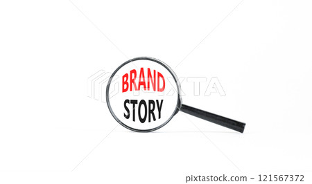 Brand story branding symbol. Concept words Brand story on beautiful white paper in magnifying glass. Beautiful white paper background. Business brand story branding concept. Copy space. Brand story branding symbol. Concept words Brand story on beautiful white paper in magnifying glass. Beautiful white paper background. Business brand story branding concept. Copy space. 121567372