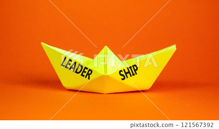 Leadership symbol. Concept word Leadership on beautiful yellow paper boat. Beautiful orange background. Business leadership concept. Copy space. Leadership symbol. Concept word Leadership on beautiful yellow paper boat. Beautiful orange background. Business leadership concept. Copy space. 121567392