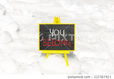 Belonging and you belong symbol. Concept words You belong on beautiful yellow chalk blackboard. Beautiful white snow background. Business belonging and you belong concept. Copy space. Belonging and you belong symbol. Concept words You belong on beautiful yellow chalk blackboard. Beautiful white snow background. Business belonging and you belong concept. Copy space. 121567421