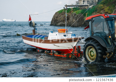 unloading the boat on the shore. pulling the boat to the beach for repairs 121567436