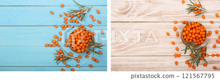 Sea buckthorn. Ripe fresh berries in bowl on blue wooden background with copy space for your text. Top view 121567795
