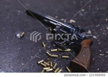 A gun with a lot of bullets next to it A gun with a lot of bullets next to it 121568493