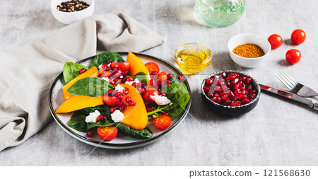 Fresh salad of persimmon, cherry tomatoes, ricotta, spinach and pomegranate on a plate web banner Fresh salad of persimmon, cherry tomatoes, ricotta, spinach and pomegranate on a plate web banner 121568630