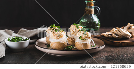 Appetizer of champignons, funchose and capelin caviar on a plate on the table web banner 121568639