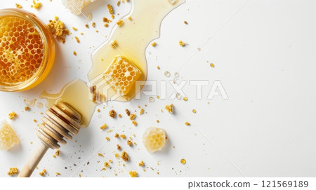 Sweet honeycomb and honey with dipper, softly lit. Pooled honey on light backdrop. Concept of sweetness, bee products, natural textures, and food origins. Banner. Copy space. Sweet honeycomb and honey with dipper, softly lit. Pooled honey on light backdrop. Concept of sweetness, bee products, natural textures, and food origins. Banner. Copy space. 121569189