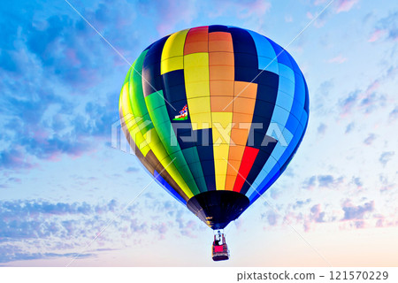 Colorful hot air balloon flying over blue sky with white clouds	 121570229