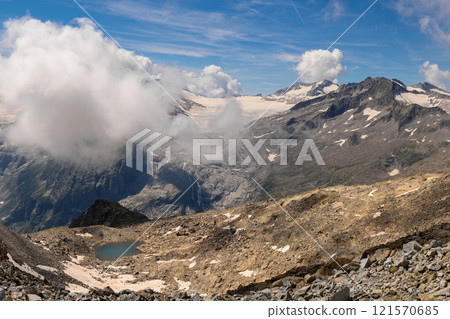 Majestic Mountain Range with Glaciers and Clouds 121570685