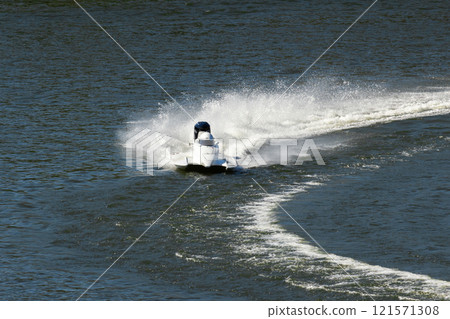 White Powerboat Making Turn on Water 121571308