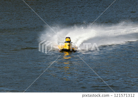 Yellow Powerboat Making Turn on Water Yellow Powerboat Making Turn on Water 121571312