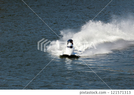 White Speedboat Making Turn on Water White Speedboat Making Turn on Water 121571313