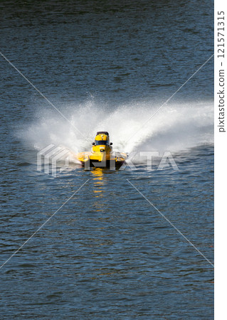 Yellow Powerboat Goes Fast on Water Yellow Powerboat Goes Fast on Water 121571315