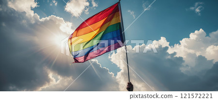 A rainbow flag wave in the wind against a cloudy sky, a sign of peace, new beginnings and change. A sign of tolerance and acceptance of the diversity of life forms 121572221