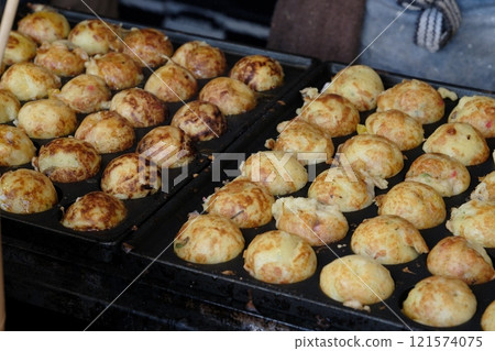 Image of large takoyaki being cooked 121574075