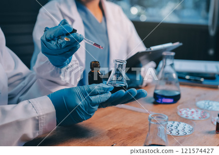 Blood test in the laboratory. Laboratory assistant working with the dispenser. Vacuum tubes with blood. Blood test in the laboratory. Laboratory assistant working with the dispenser. Vacuum tubes with blood. 121574427