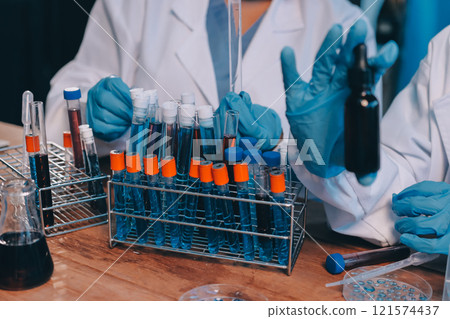 Blood test in the laboratory. Laboratory assistant working with the dispenser. Vacuum tubes with blood. Blood test in the laboratory. Laboratory assistant working with the dispenser. Vacuum tubes with blood. 121574437