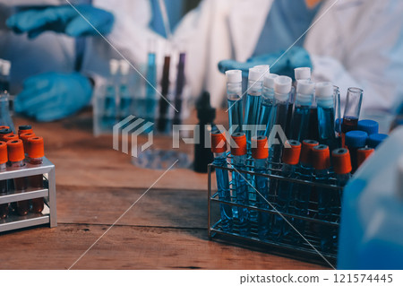 Blood test in the laboratory. Laboratory assistant working with the dispenser. Vacuum tubes with blood. Blood test in the laboratory. Laboratory assistant working with the dispenser. Vacuum tubes with blood. 121574445