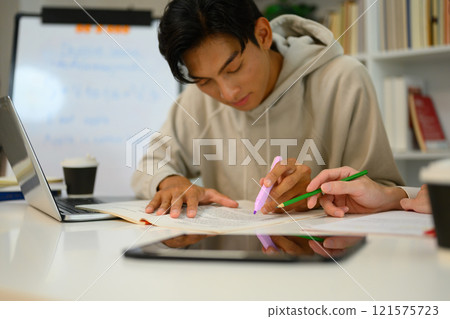 Asian male student studying with tutor at home. Education, knowledge and tutoring concept 121575723