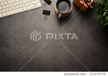 Stylish workspace with a cup of coffee and keyboard on dark grey stone background 121575734