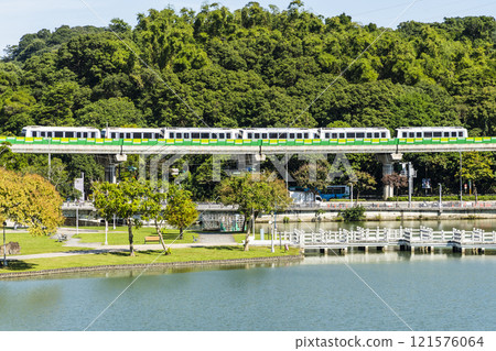A train traveling on the Wenhu or Brown Line of the Taipei MRT, Taiwan, passes by Taipei Dahu Park. A train traveling on the Wenhu or Brown Line of the Taipei MRT, Taiwan, passes by Taipei Dahu Park. 121576064