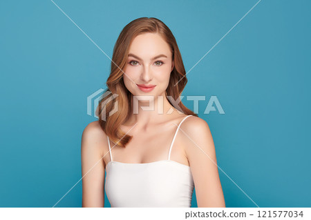 Beautiful young woman with clean fresh skin on blue background, Face care, Facial treatment, Cosmetology, beauty and spa, women portrait. Beautiful young woman with clean fresh skin on blue background, Face care, Facial treatment, Cosmetology, beauty and spa, women portrait. 121577034