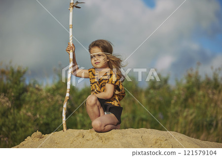 Cute baby dressed in the clothes of primitive people 121579104